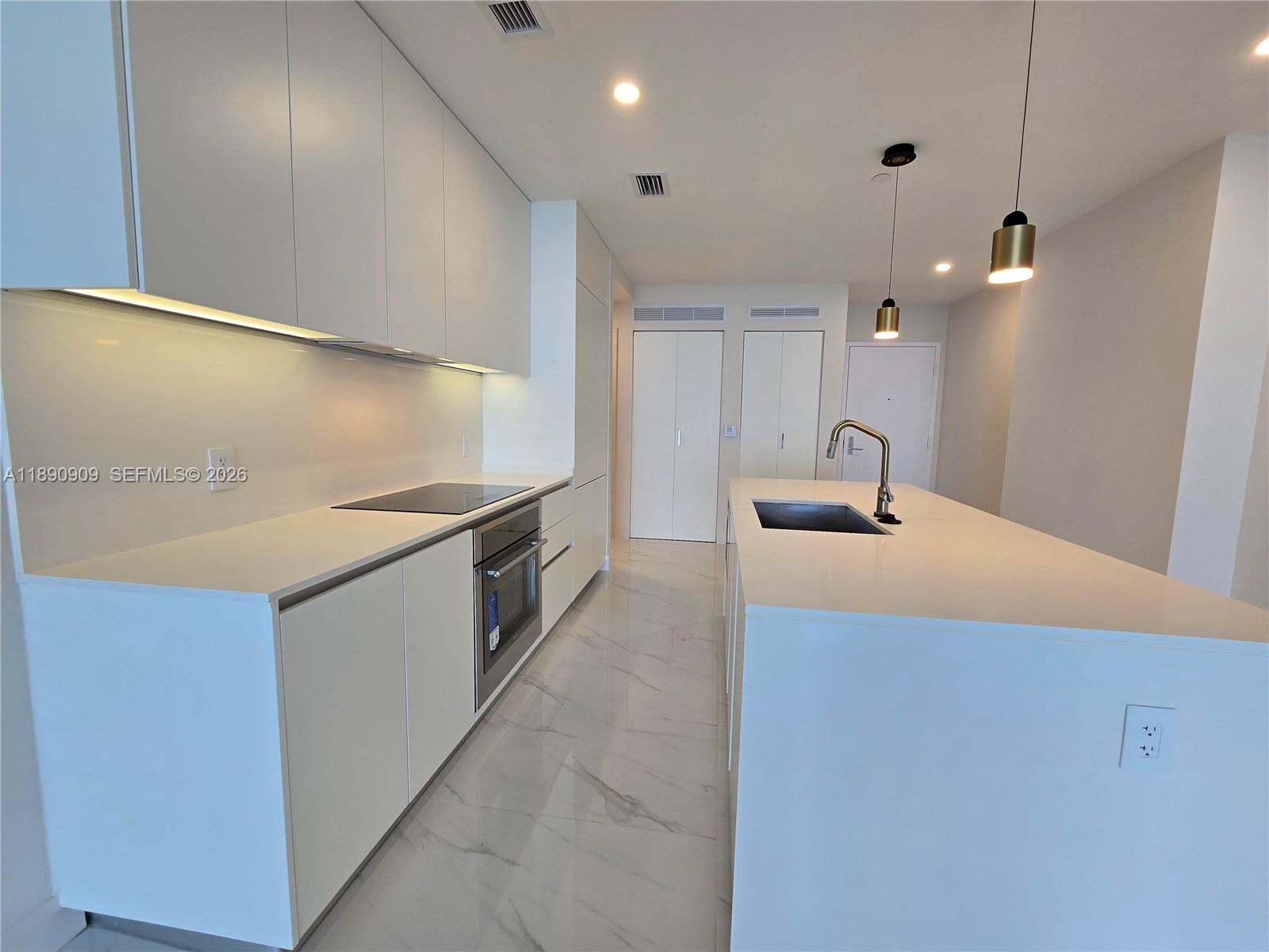 700 Northeast 24th Street, Unit 4004 Miami, FL 33137 - Photo 16 of 68 a kitchen with stainless steel appliances a sink and a refrigerator