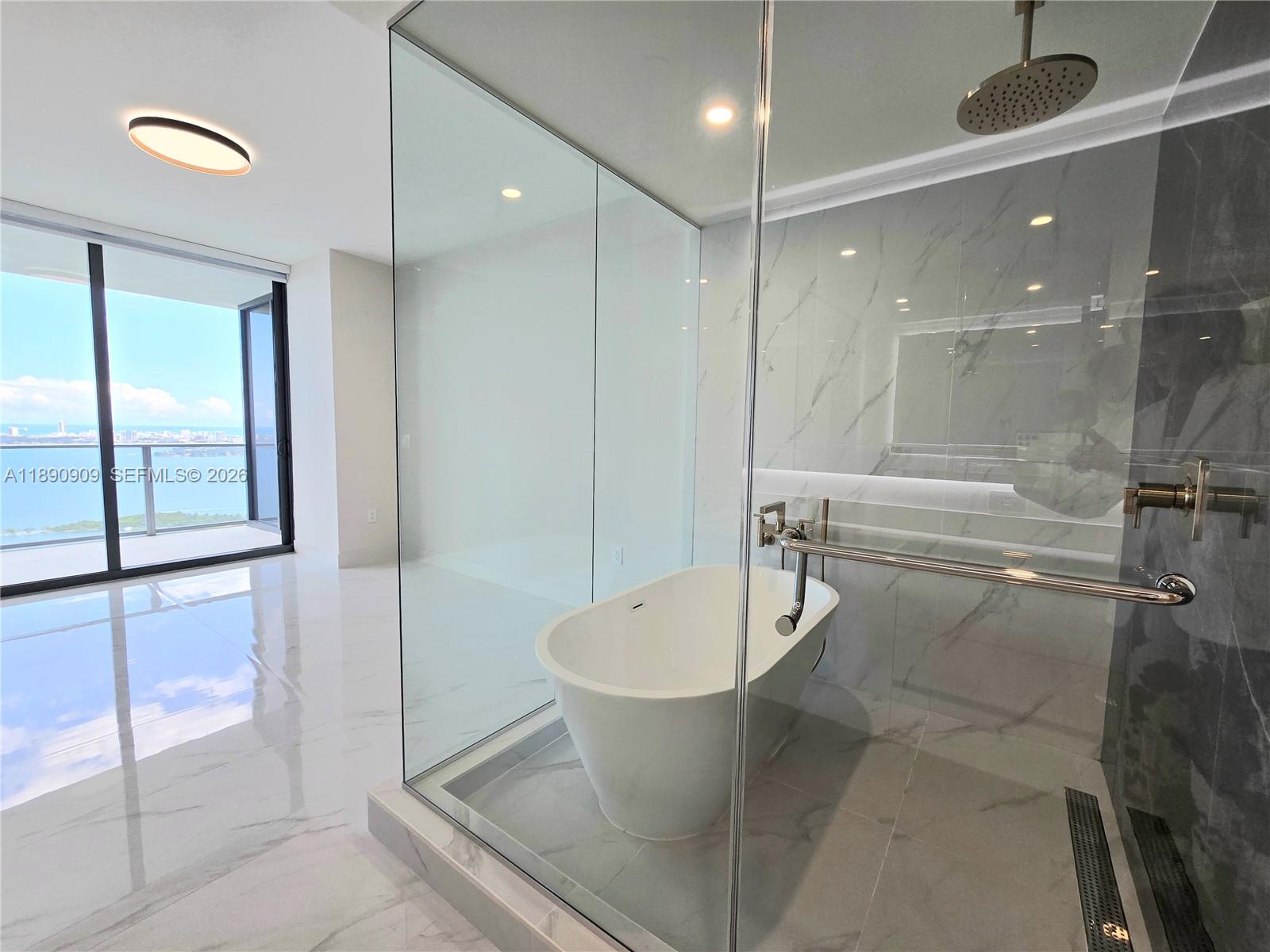 700 Northeast 24th Street, Unit 4004 Miami, FL 33137 - Photo 36 of 68 a bathroom with a toilet a sink and bathtub