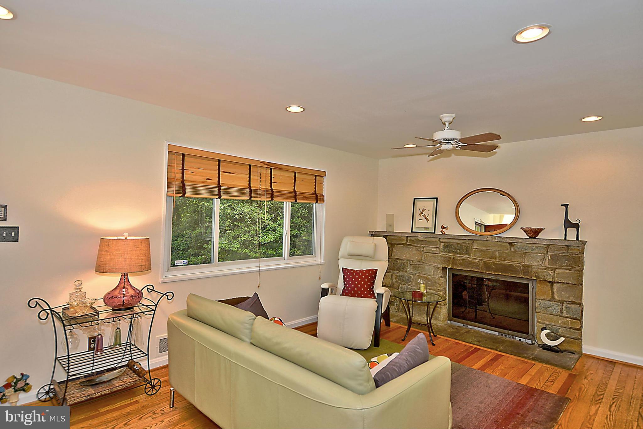 15 Park Valley Road Silver Spring, MD 20910 - Photo 13 of 30 a living room with furniture a fireplace and a large window