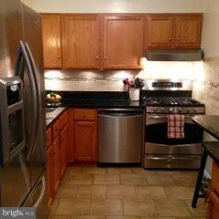 15 Park Valley Road Silver Spring, MD 20910 - Photo 7 of 30 a kitchen with wooden cabinets and a stove top oven