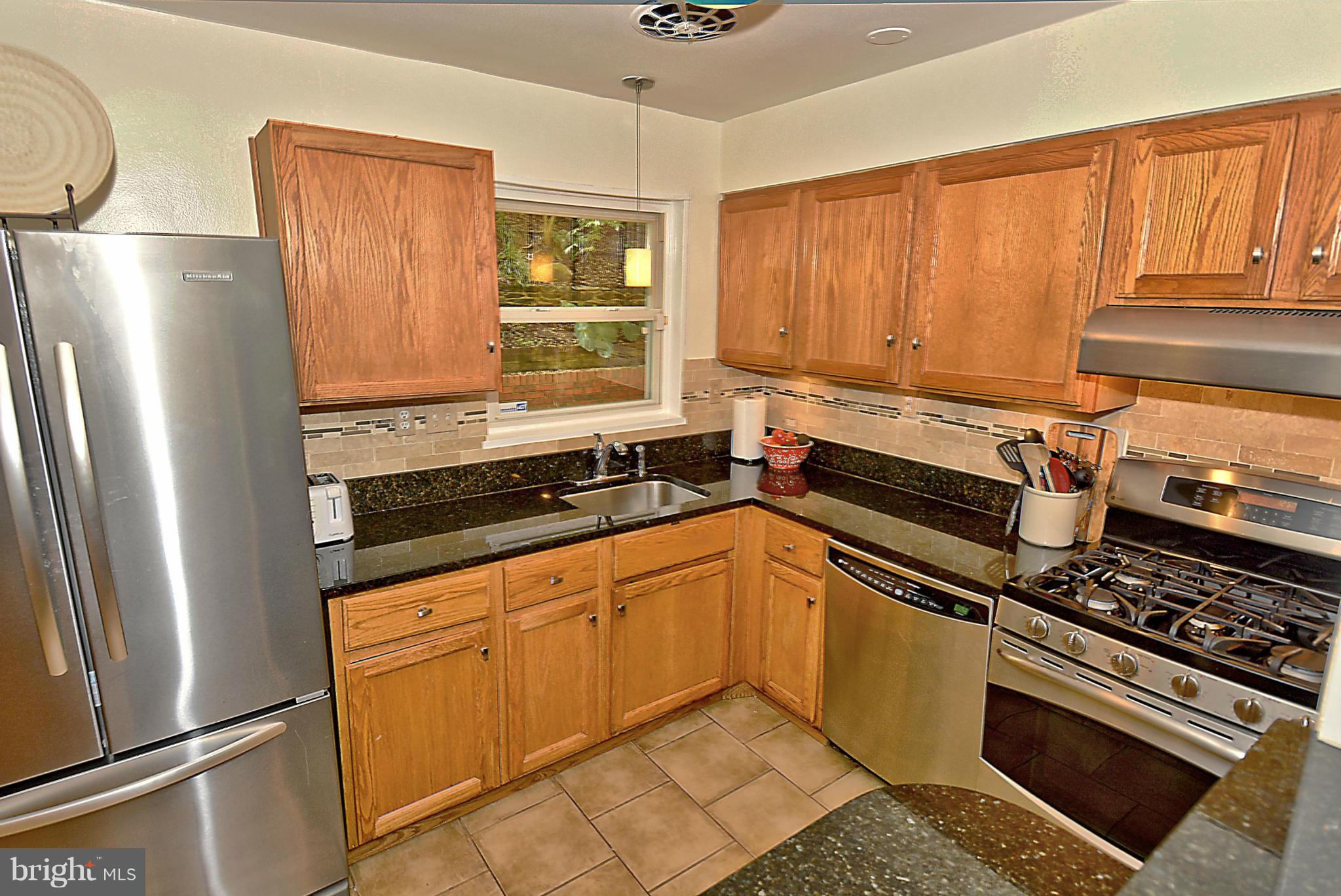 15 Park Valley Road Silver Spring, MD 20910 - Photo 8 of 30 a kitchen with a refrigerator a stove a sink and cabinets