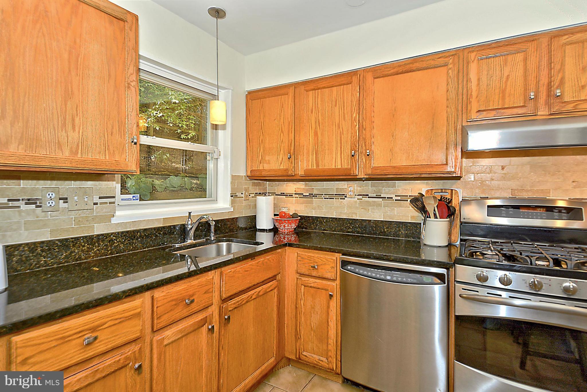 15 Park Valley Road Silver Spring, MD 20910 - Photo 9 of 30 a kitchen with stainless steel appliances a stove sink and cabinets