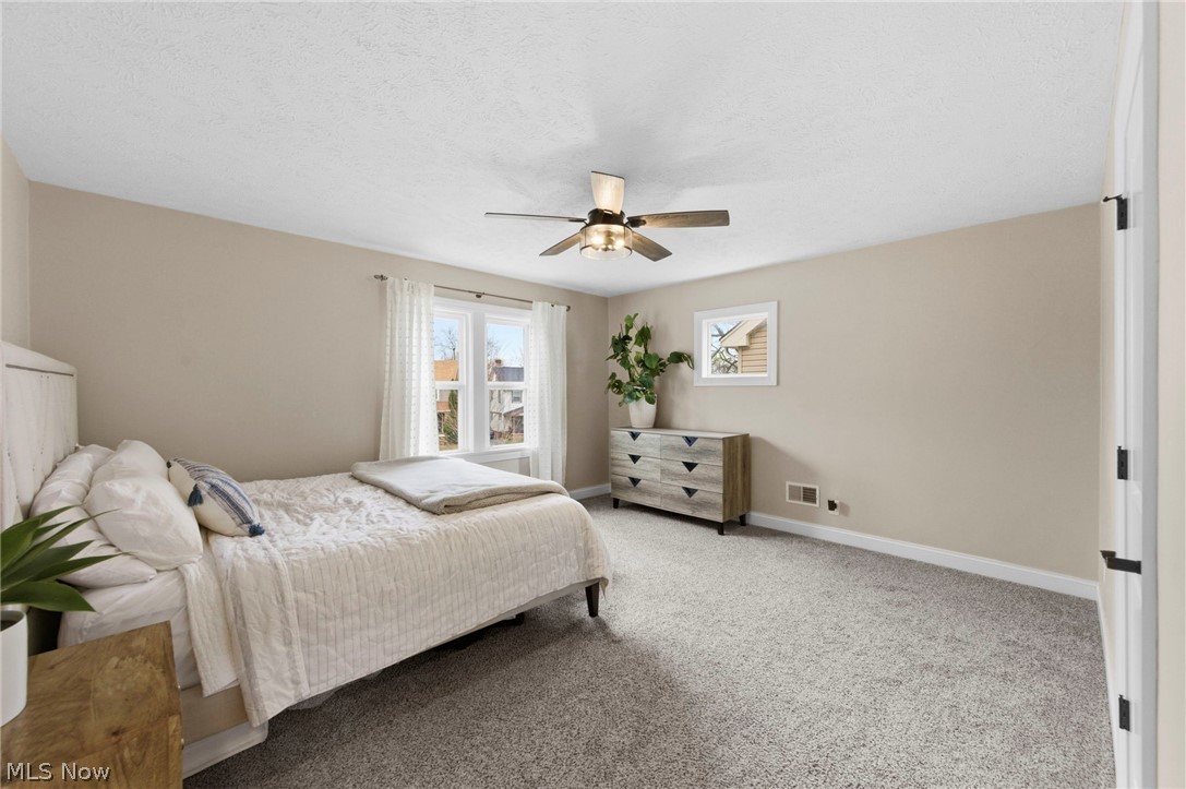 3525 Silsby Road Cleveland, OH 44118 - Photo 14 of 44 Bedroom featuring carpet floors, ceiling fan, and a textured ceiling