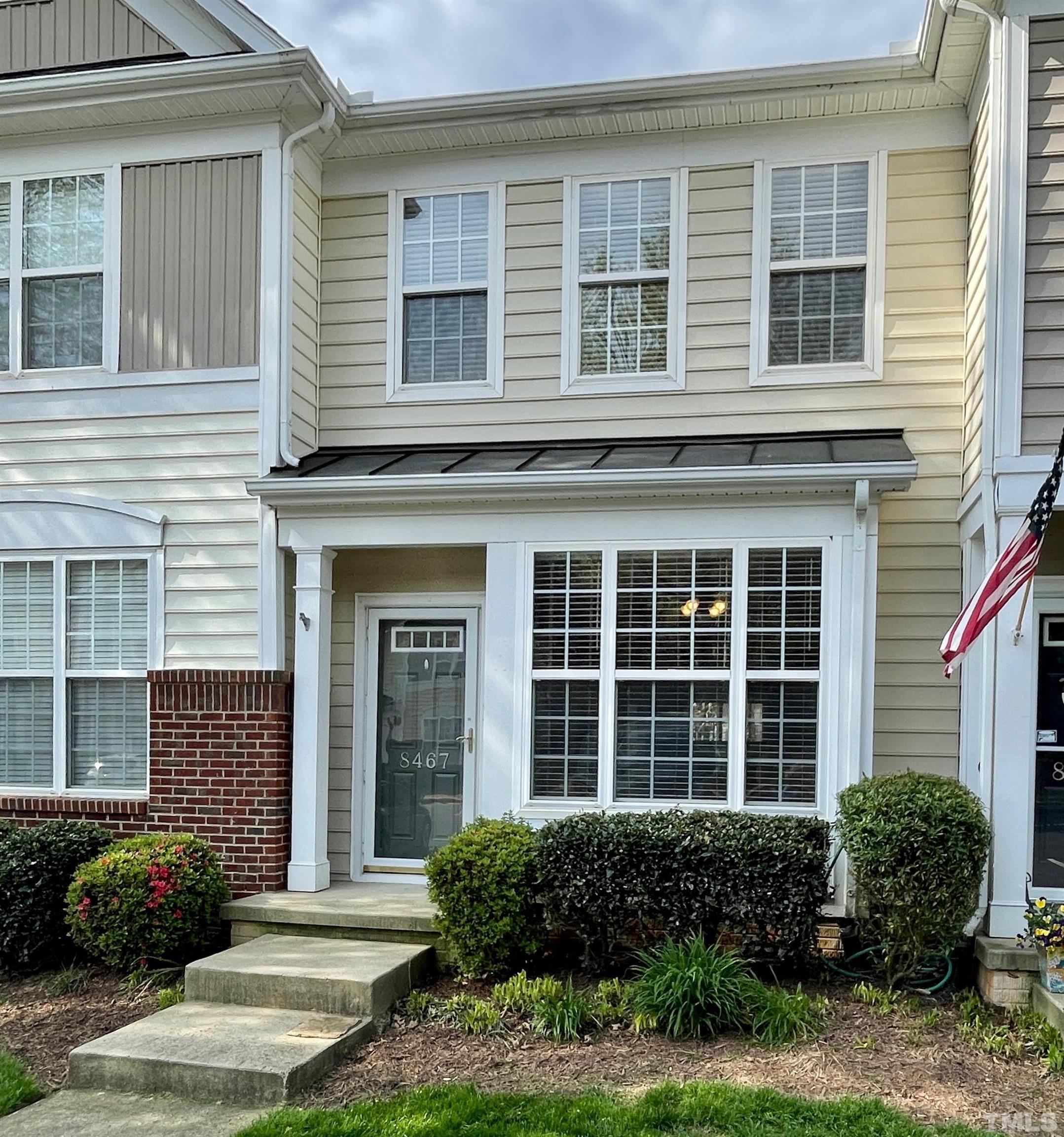 8467 Reedy Ridge Lane Raleigh, NC 27613 - Photo 1 of 46 a front view of a house with a yard and outdoor seating
