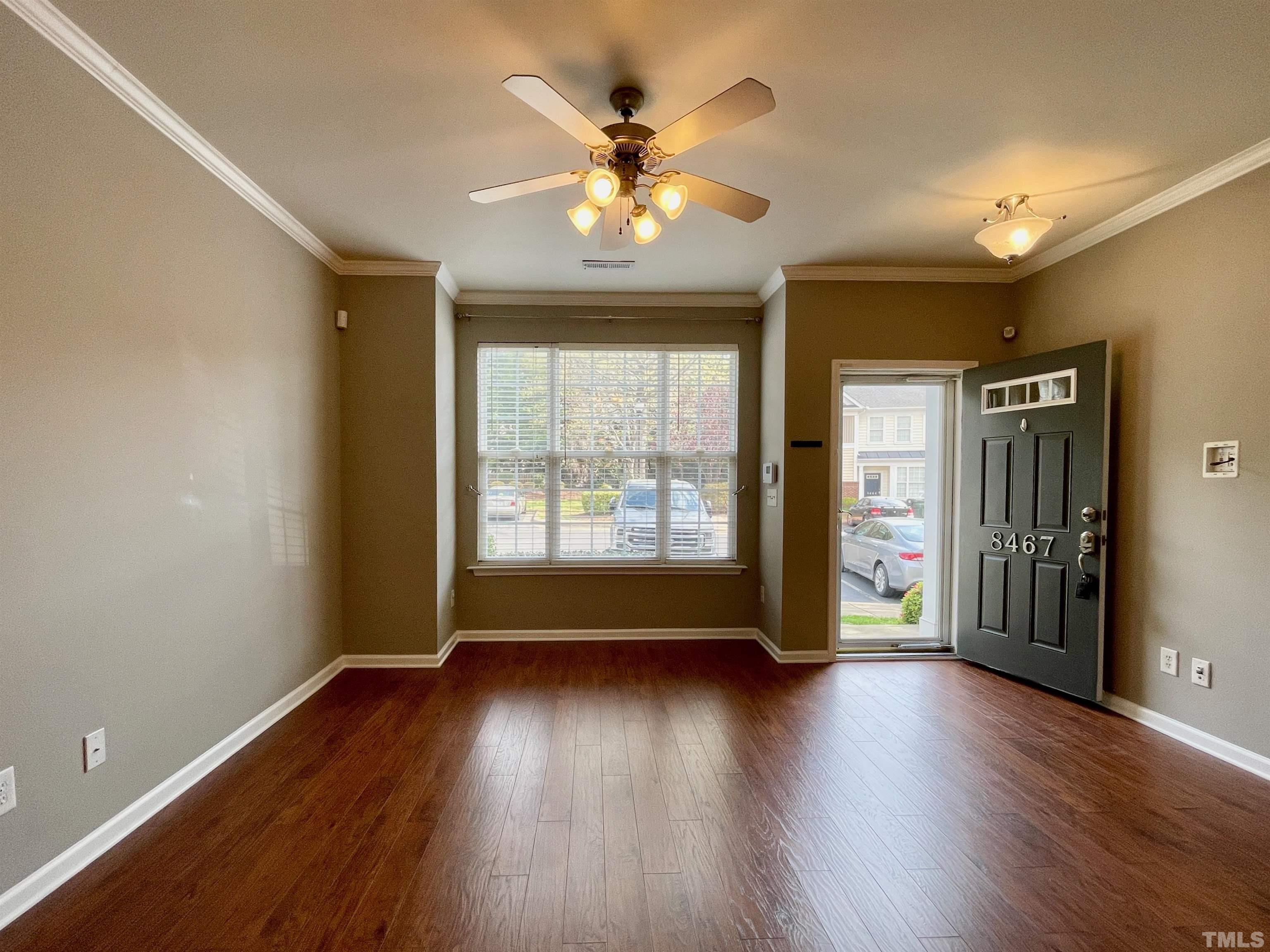 8467 Reedy Ridge Lane Raleigh, NC 27613 - Photo 12 of 46 an empty room with wooden floor and windows