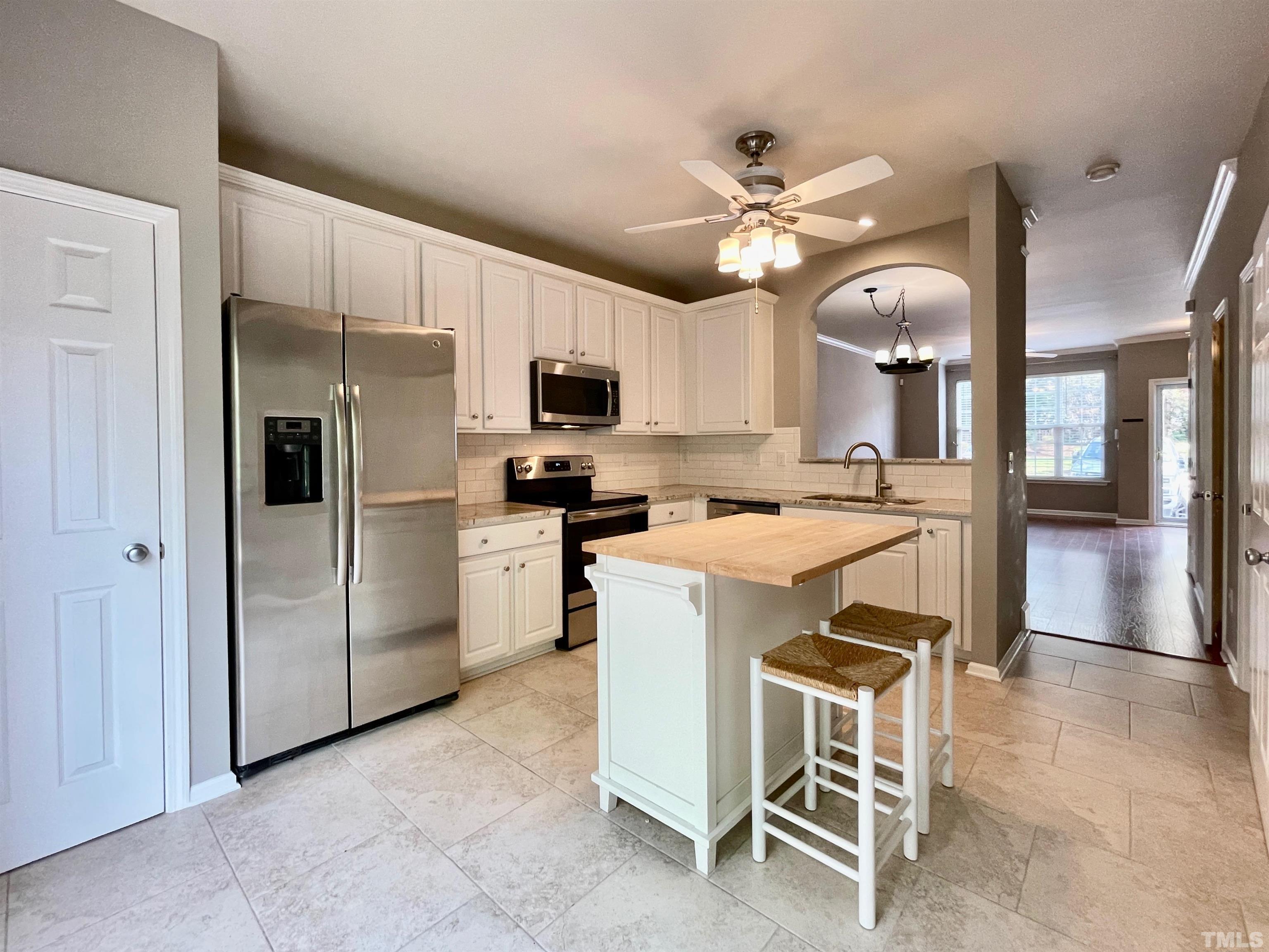 8467 Reedy Ridge Lane Raleigh, NC 27613 - Photo 15 of 46 a kitchen with kitchen island appliances cabinets and furniture