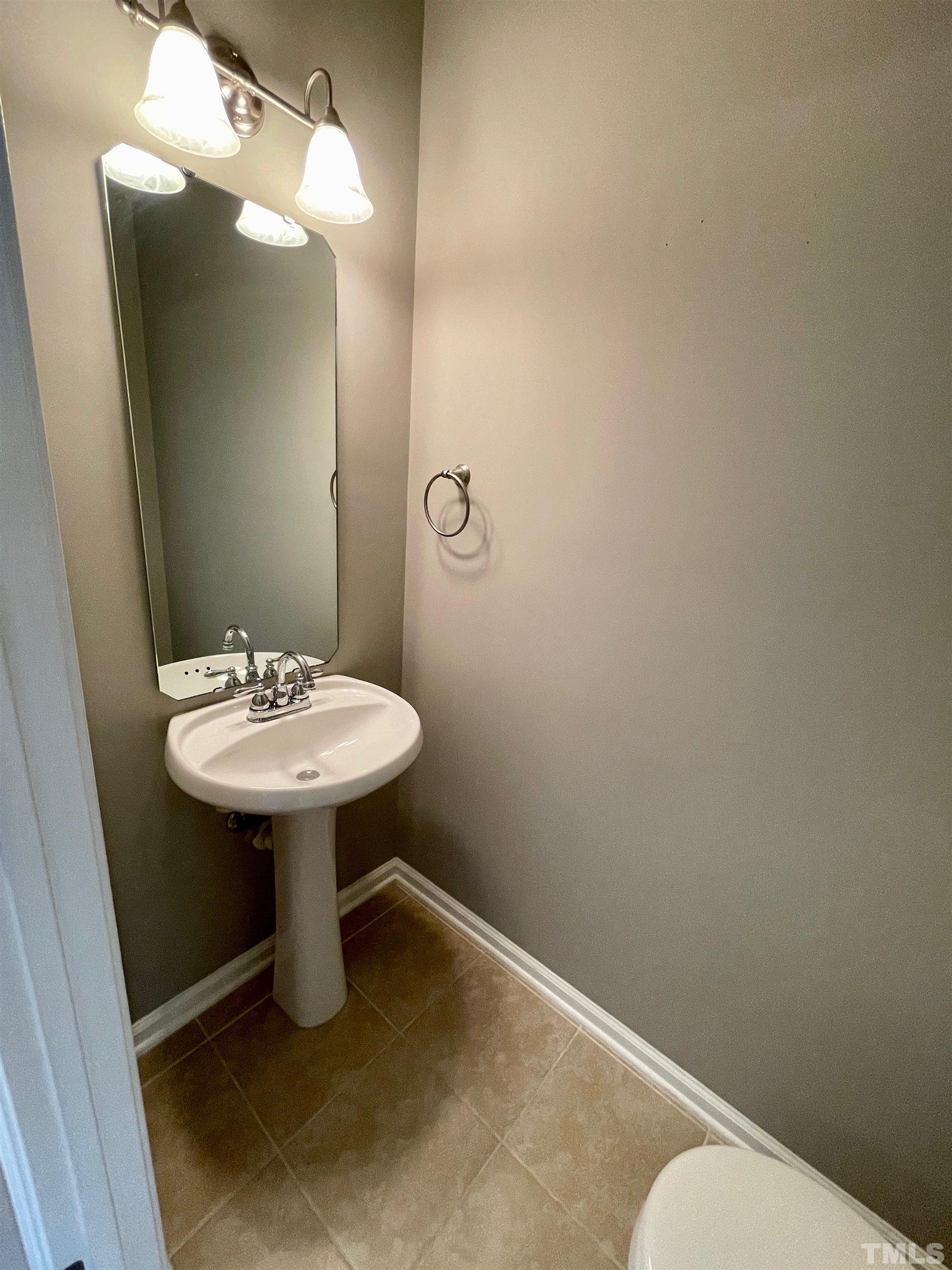 8467 Reedy Ridge Lane Raleigh, NC 27613 - Photo 23 of 46 a bathroom with a sink toilet and mirror