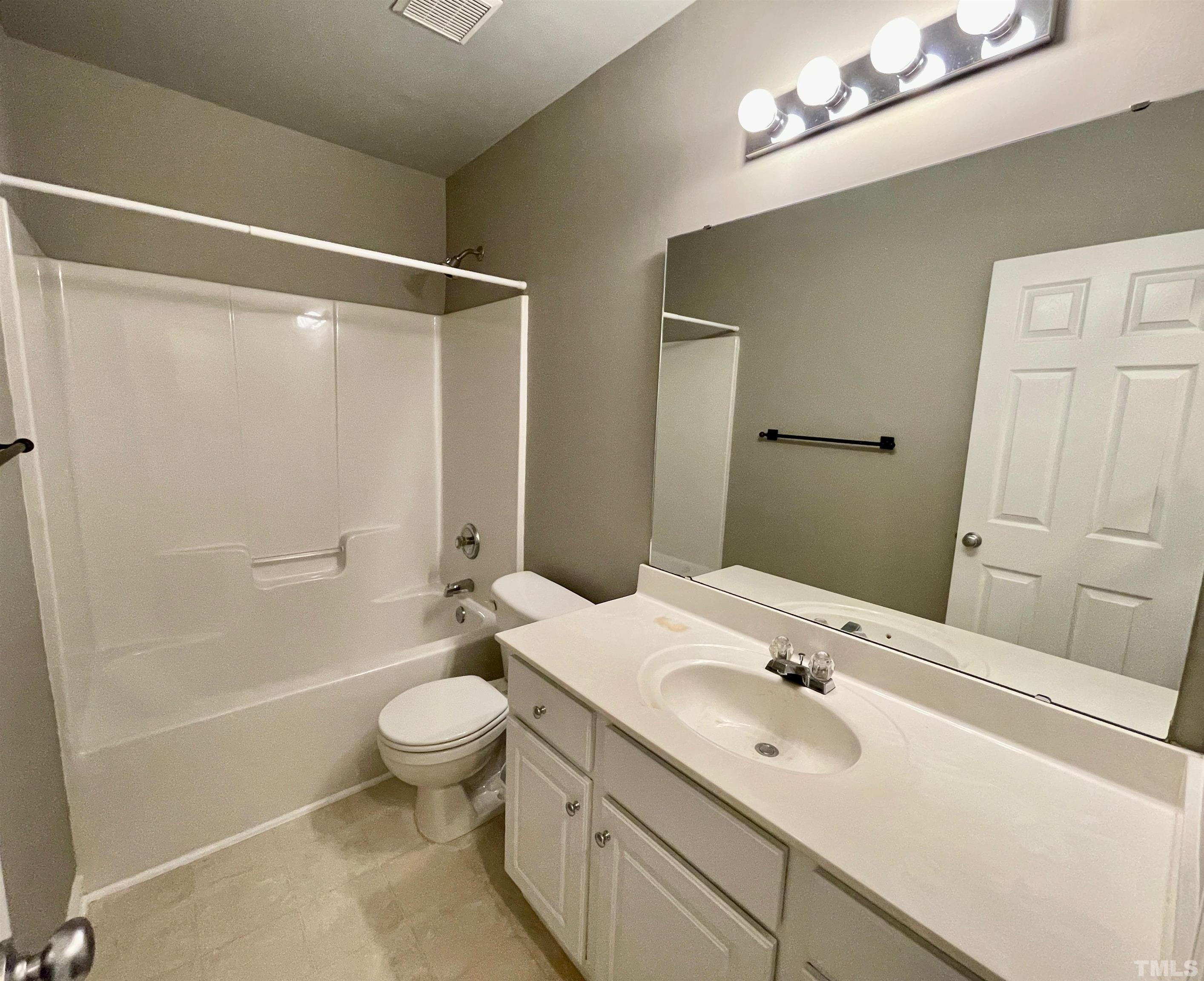 8467 Reedy Ridge Lane Raleigh, NC 27613 - Photo 41 of 46 a bathroom with a sink a toilet a mirror and shower