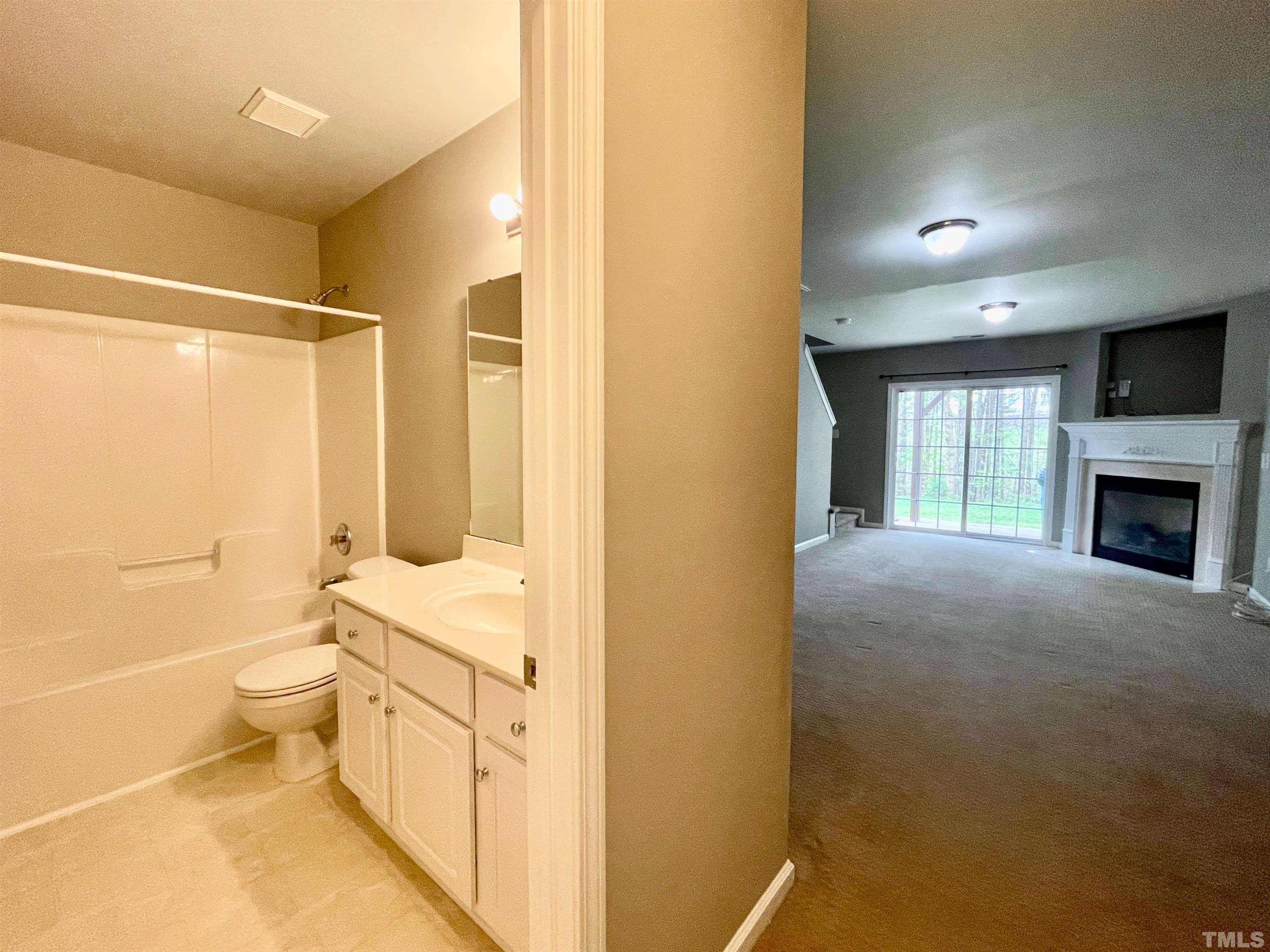 8467 Reedy Ridge Lane Raleigh, NC 27613 - Photo 42 of 46 a bathroom with a granite countertop sink a toilet and shower