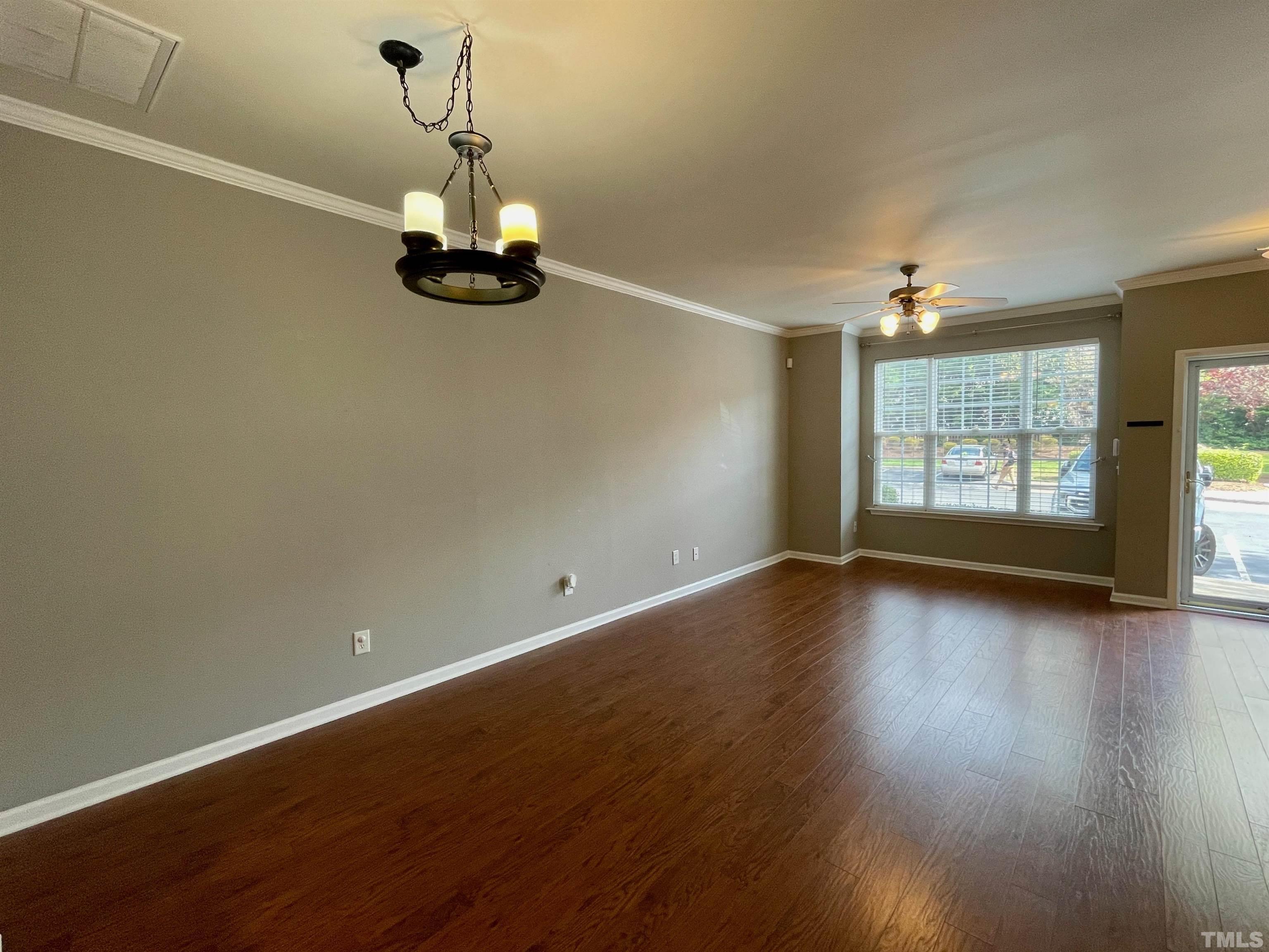 8467 Reedy Ridge Lane Raleigh, NC 27613 - Photo 8 of 46 an empty room with wooden floor and windows