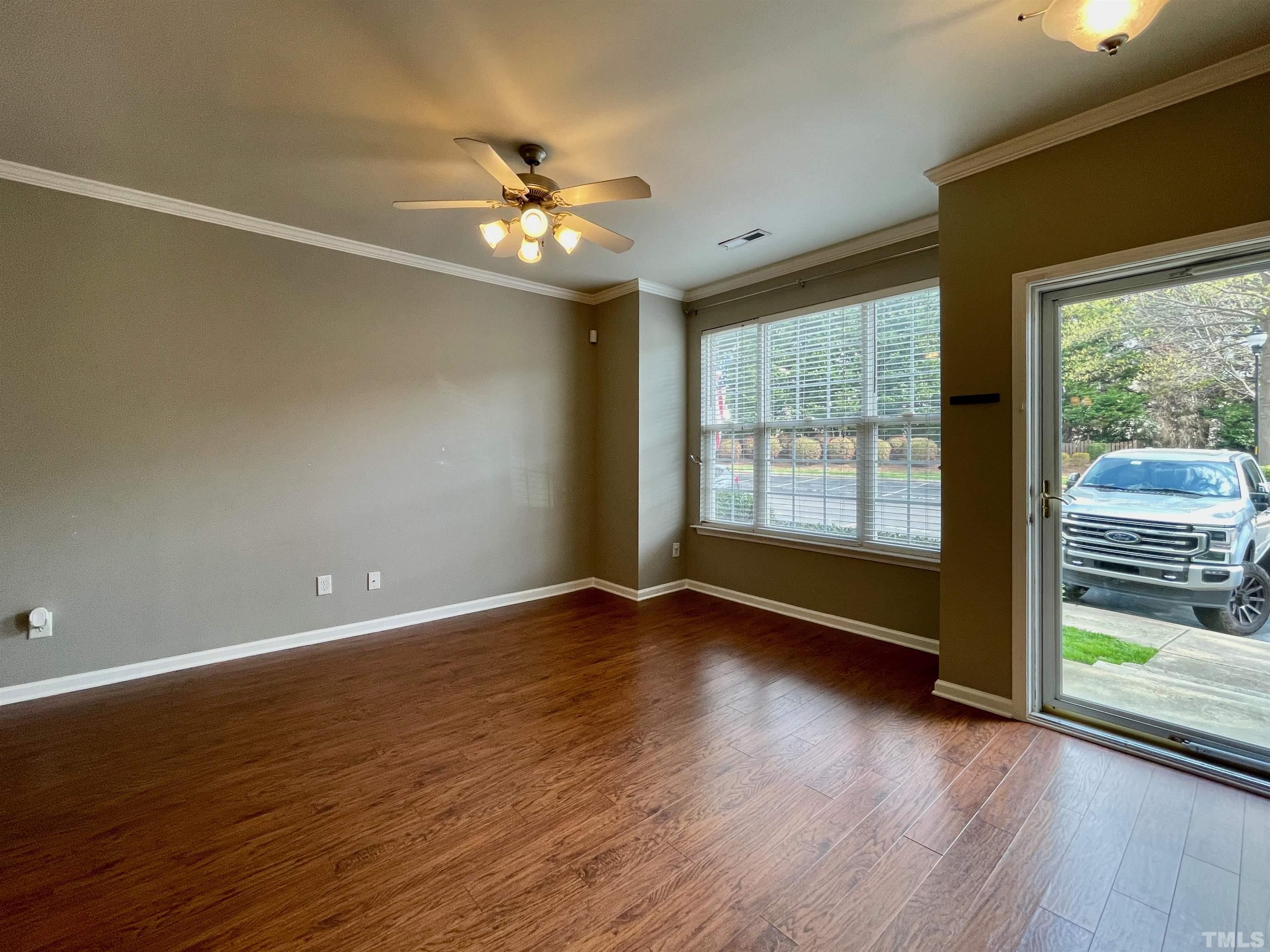 8467 Reedy Ridge Lane Raleigh, NC 27613 - Photo 10 of 46 a view of an empty room with wooden floor and a window