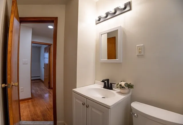 a bathroom with a toilet sink and mirror