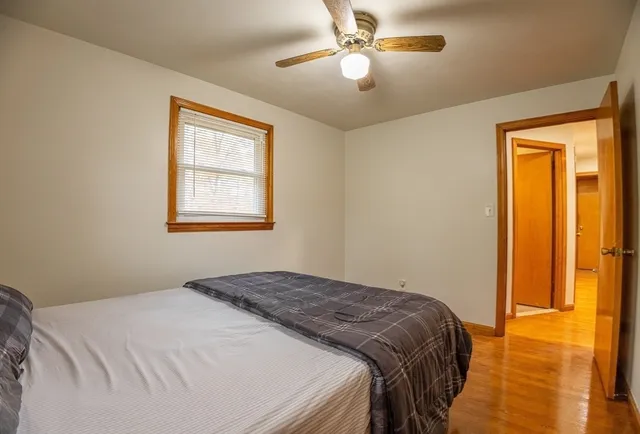 a bedroom with a bed and a window