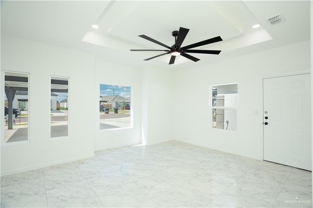 1408 South Xanthia Street, Unit 1 Alton, TX 78573 - Photo 3 of 19 a view of a livingroom with a ceiling fan and window