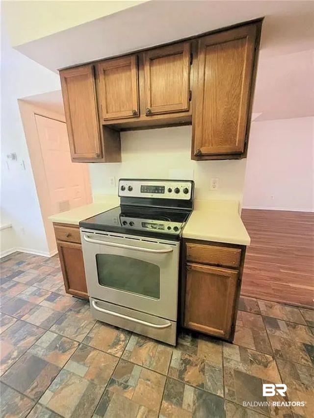6701 Dickens Ferry Road, Unit 53 Mobile, AL 36608 - Photo 3 of 23 Kitchen with stainless steel electric range and light countertops