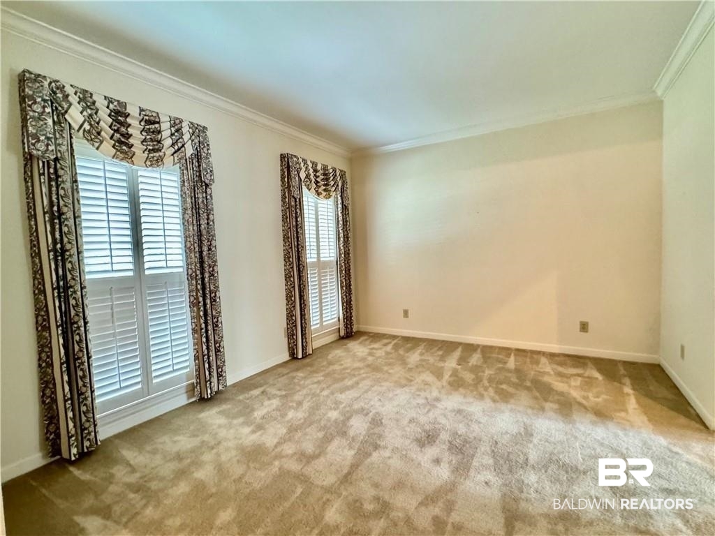 3932 Mcgregor Court Mobile, AL 36608 - Photo 7 of 9 Spare room featuring ornamental molding and carpet floors