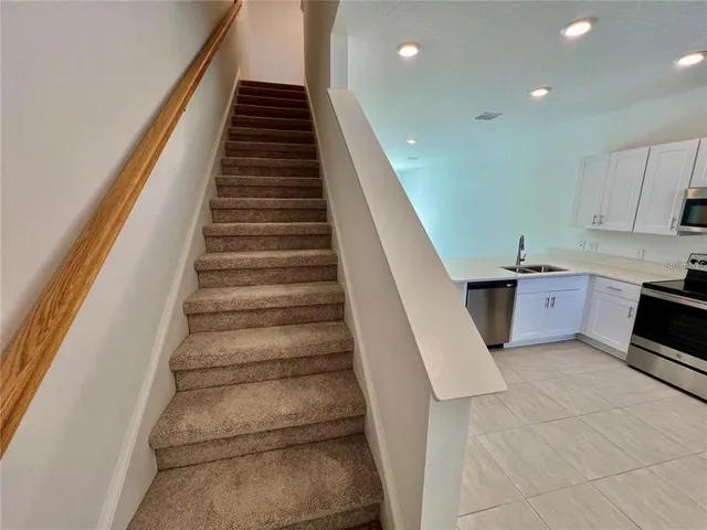 a view of a kitchen with sink and cabinets