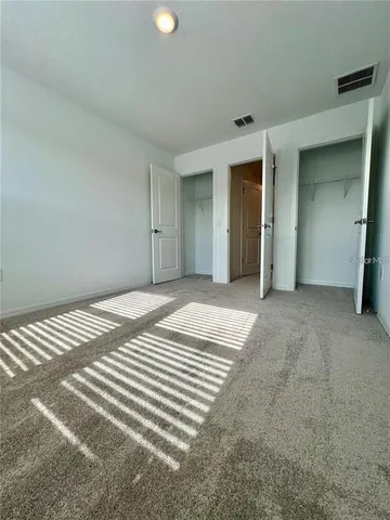 a view of a livingroom with wooden floor and closet