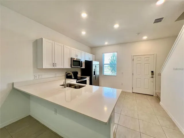 a kitchen with a sink a stove and cabinets