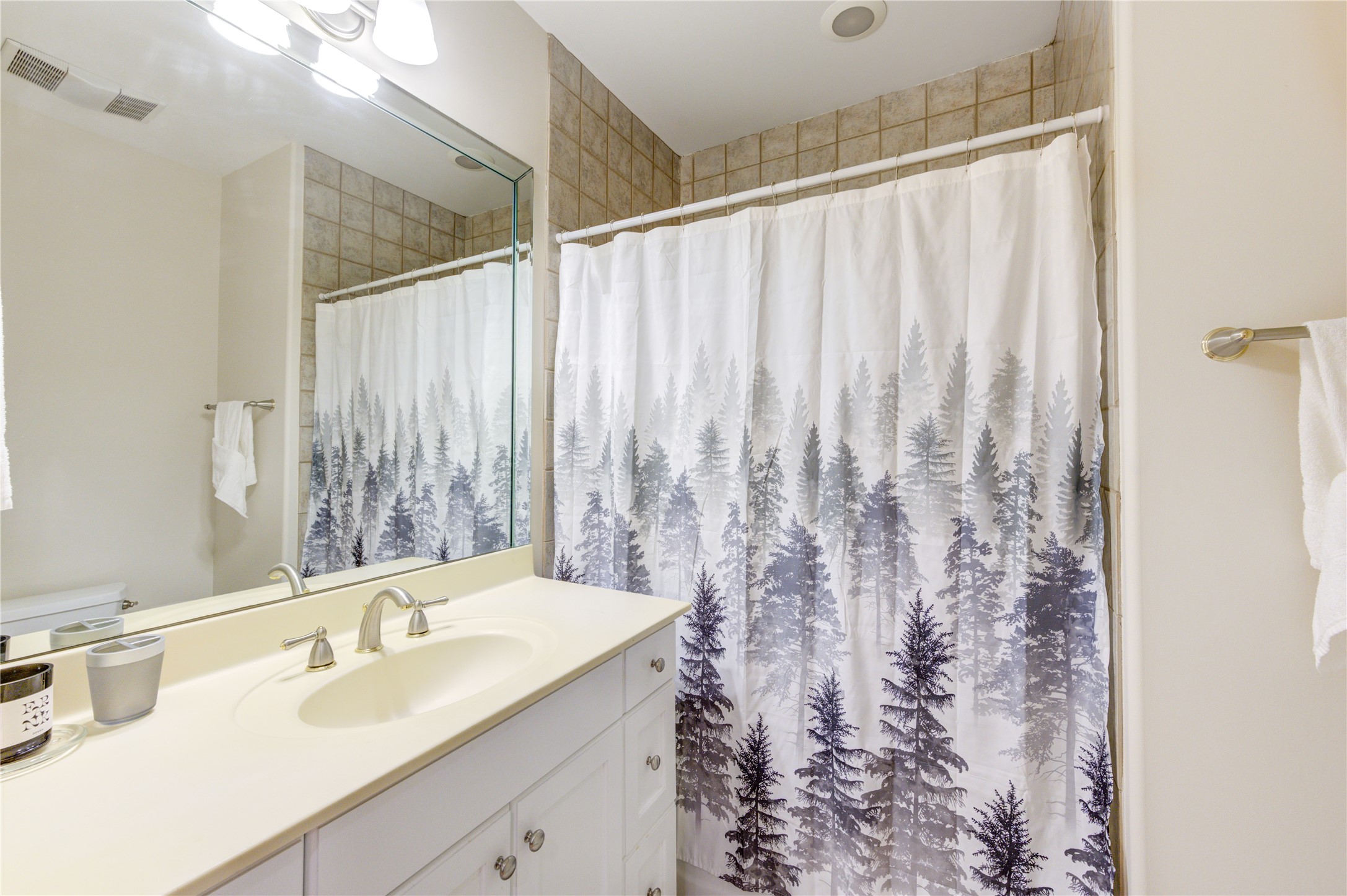 914 Main Street, Unit 911 Houston, TX 77002 - Photo 17 of 30 a bathroom with a granite countertop sink and a mirror