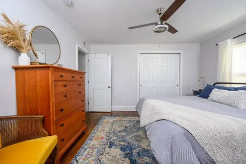 a bedroom with a bed and a dresser