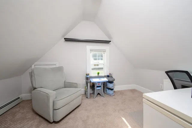 a living room with furniture and white walls