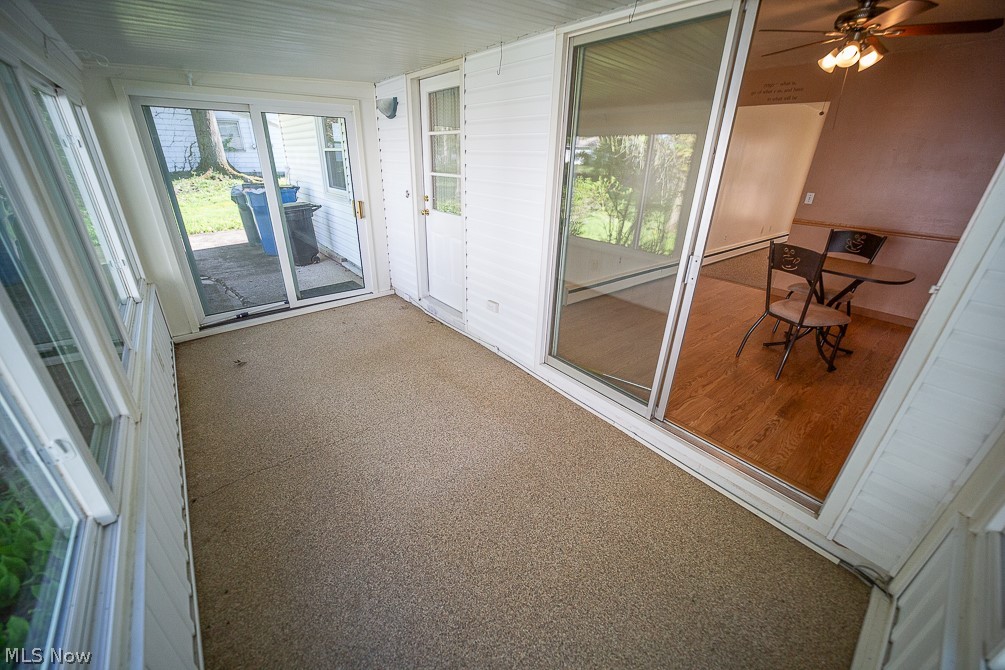 495 High Meadow Road Amherst, OH 44001 - Photo 23 of 39 3 season room looking into the eat in kitchen & the back yard.