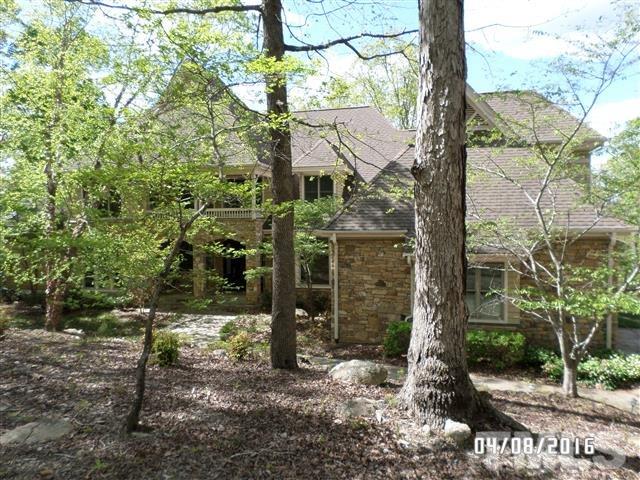a house is sitting in middle of forest