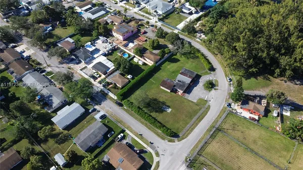 an aerial view of a residential houses with outdoor space