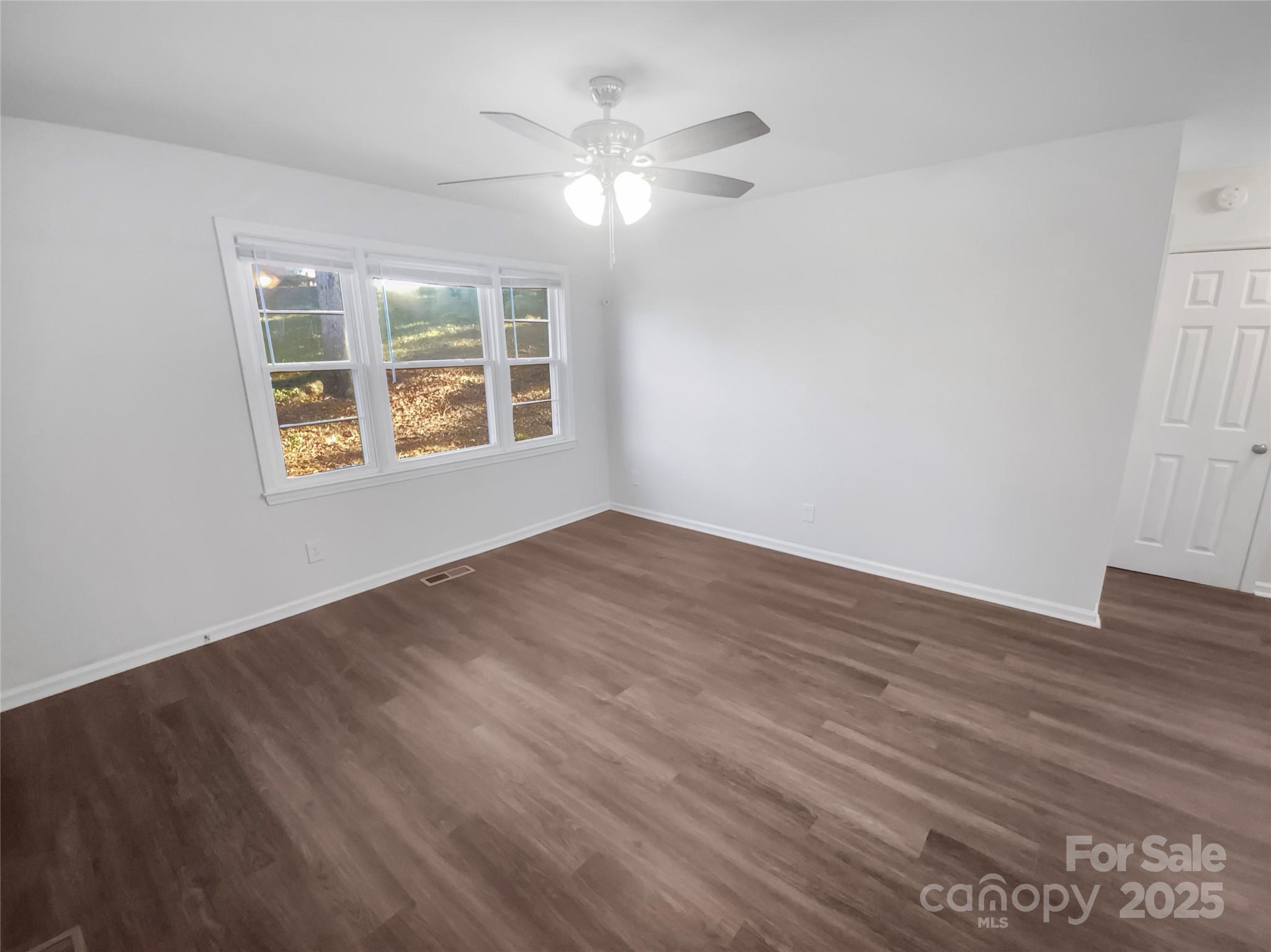 349 Wakefield Drive, Unit A Charlotte, NC 28209 - Photo 11 of 20 a view of an empty room with wooden floor and a window