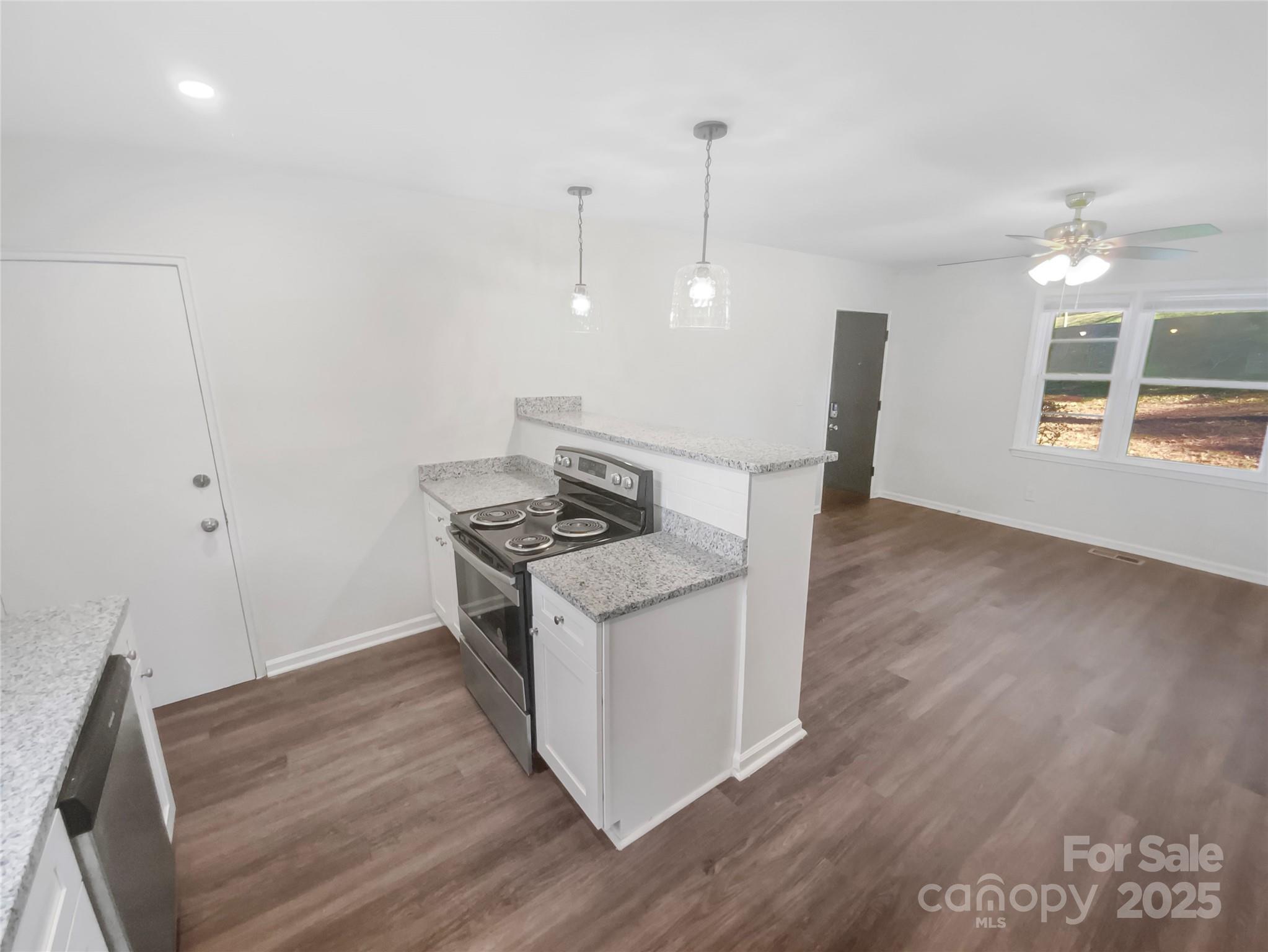 349 Wakefield Drive, Unit A Charlotte, NC 28209 - Photo 13 of 20 a kitchen with a stove and a wooden floor