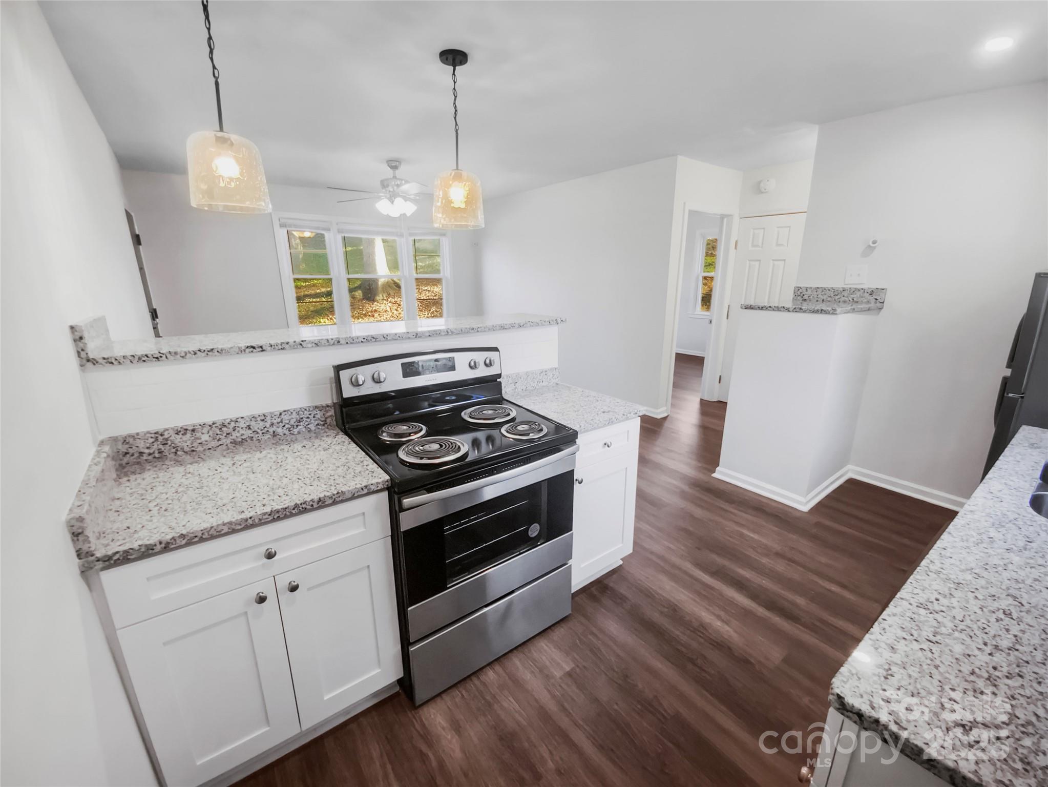 349 Wakefield Drive, Unit A Charlotte, NC 28209 - Photo 14 of 20 a kitchen with a stove and a wooden floor
