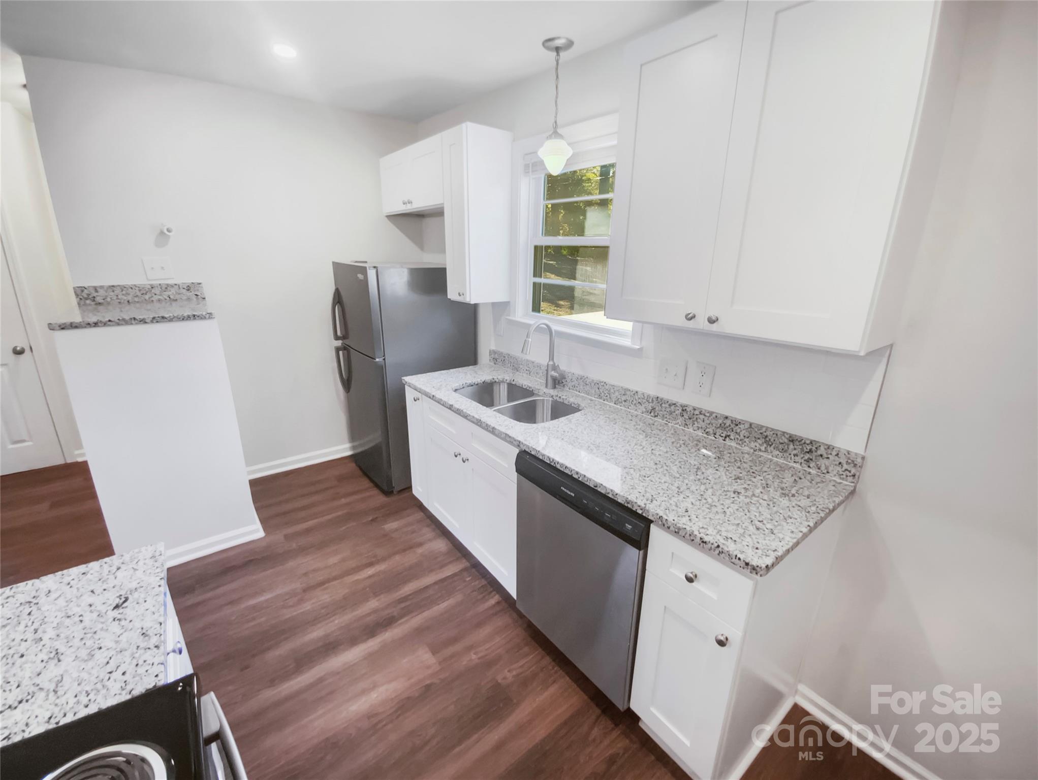 349 Wakefield Drive, Unit A Charlotte, NC 28209 - Photo 2 of 20 a kitchen with granite countertop a sink stove and refrigerator