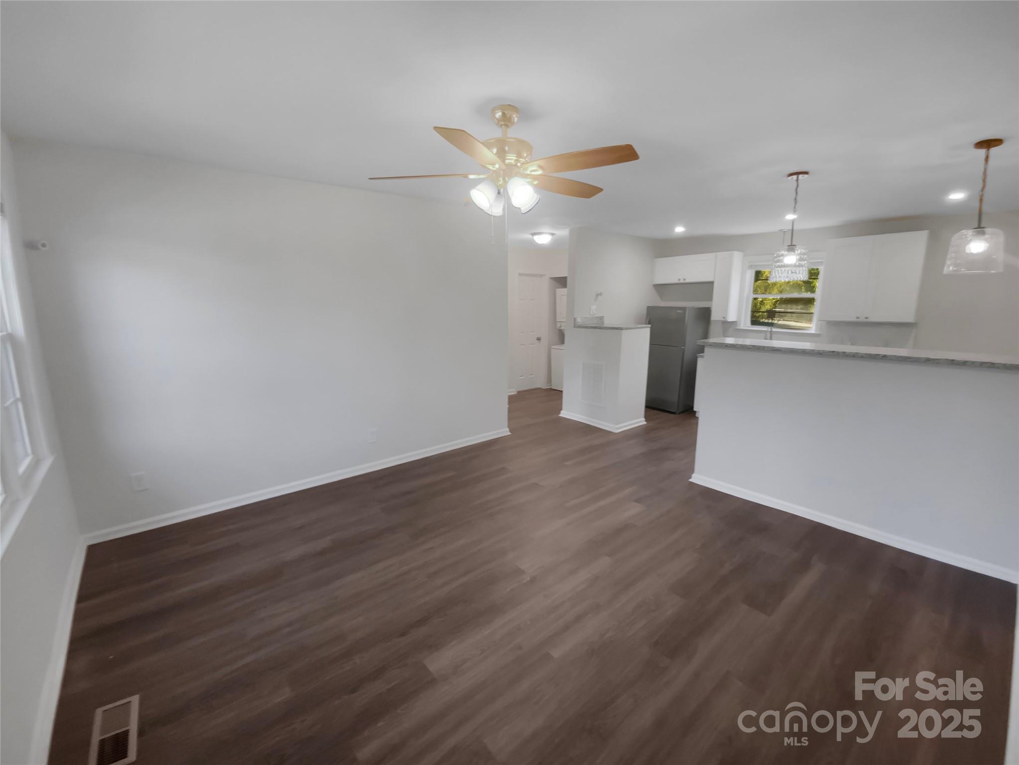 349 Wakefield Drive, Unit A Charlotte, NC 28209 - Photo 9 of 20 a view of a kitchen with wooden floor and a ceiling fan