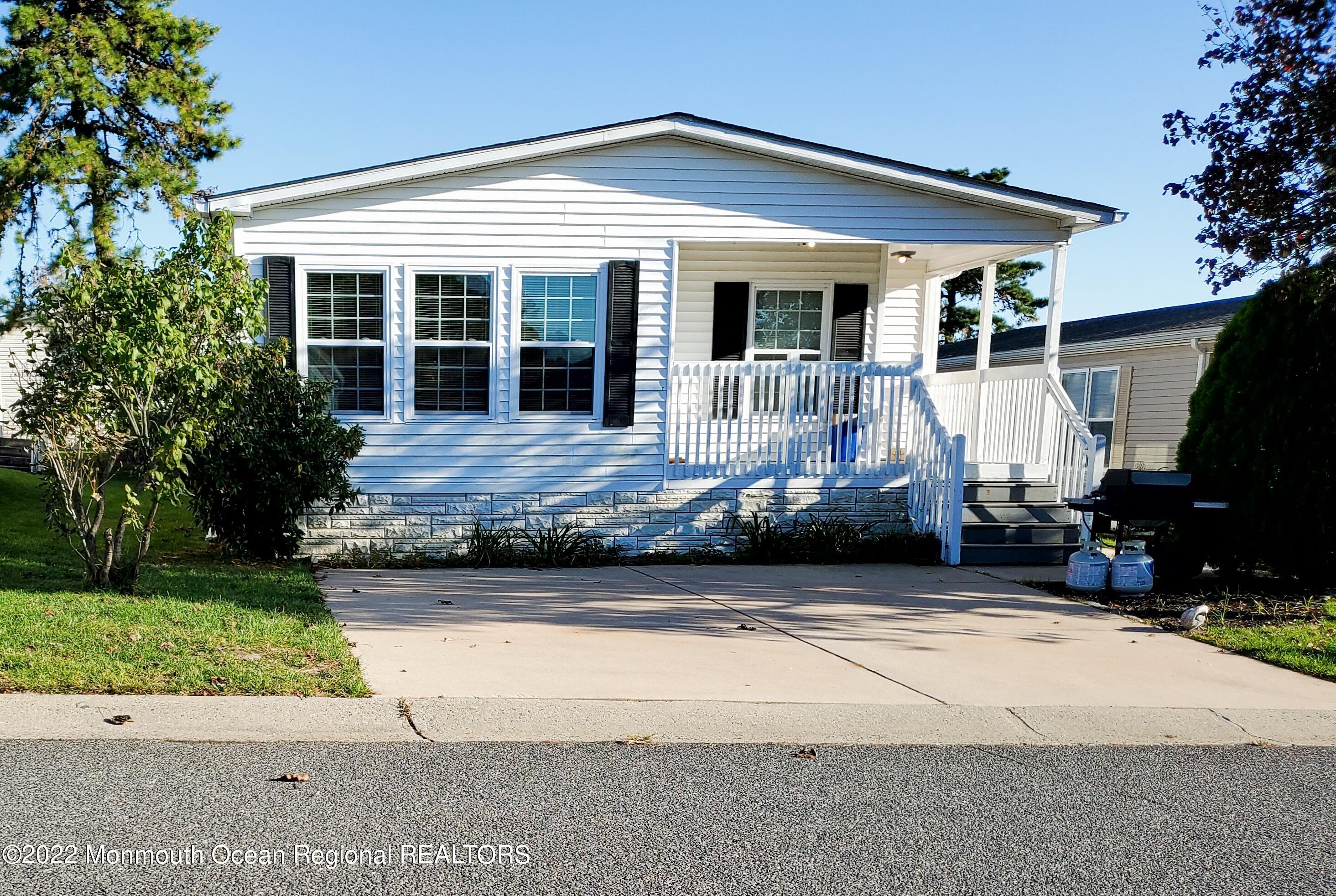 29 Pine Ridge Boulevard Whiting, NJ 08759 - Photo 1 of 29 a front view of a house with garden