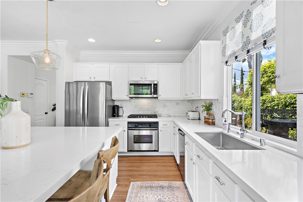 14 Celestine Circle Ladera Ranch, CA 92694 - Photo 14 of 42 a kitchen with stainless steel appliances granite countertop a sink stove and refrigerator