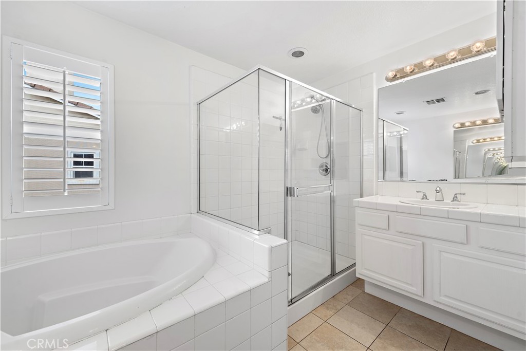 14 Celestine Circle Ladera Ranch, CA 92694 - Photo 21 of 42 a spacious bathroom with a granite countertop sink a mirror a bathtub and shower
