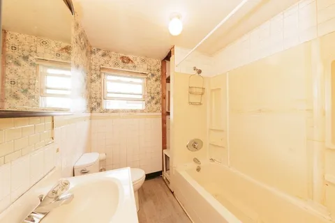 a bathroom with a bathtub and shower