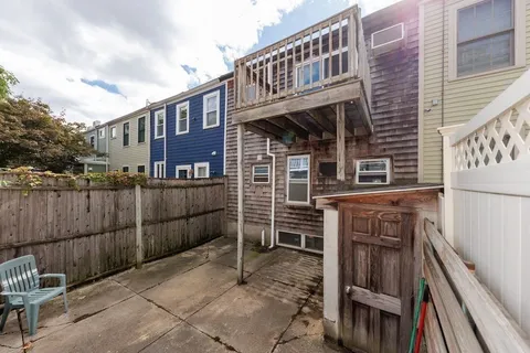 a front view of a house with iron fence