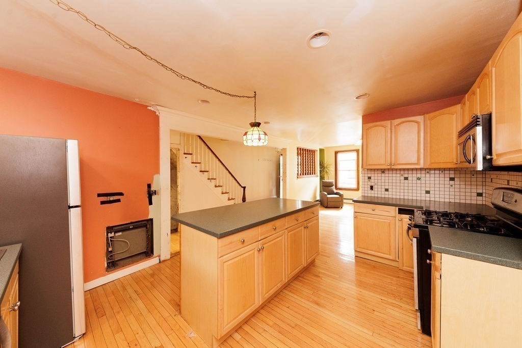 33 Russell Street Boston, MA 02129 - Photo 6 of 27 a kitchen with stainless steel appliances a sink and a refrigerator