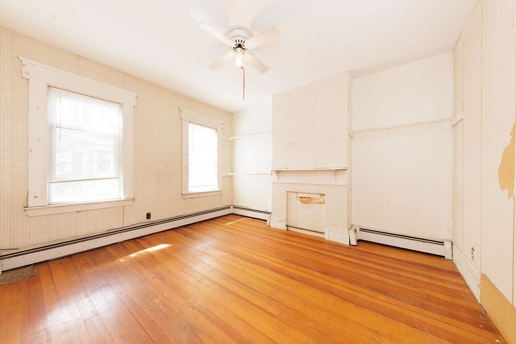 33 Russell Street Boston, MA 02129 - Photo 9 of 27 an empty room with wooden floor cabinet and windows