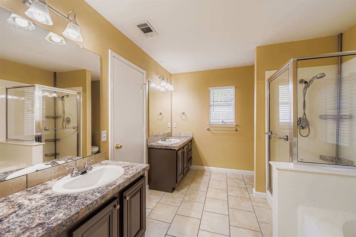 441 Keystone Loop Kyle, TX 78640 - Photo 11 of 17 a spacious bathroom with a granite countertop tub sink shower and mirror