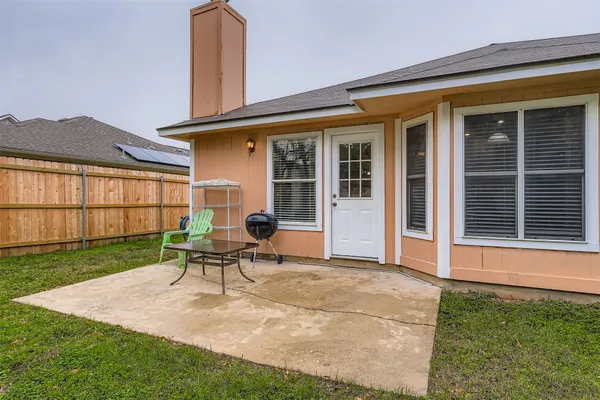 a view of an house with backyard porch and furniture