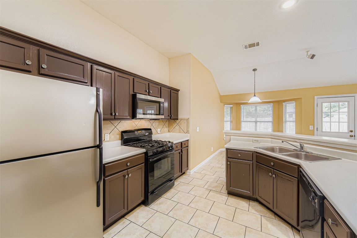 441 Keystone Loop Kyle, TX 78640 - Photo 7 of 17 a kitchen with stainless steel appliances granite countertop a sink stove and refrigerator