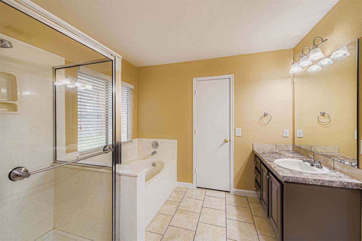 441 Keystone Loop Kyle, TX 78640 - Photo 10 of 17 a bathroom with a granite countertop sink and a mirror