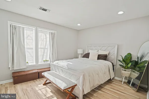 a spacious bedroom with a bed and a window