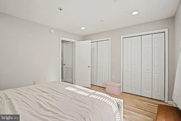 a bedroom with a bed and wooden floor