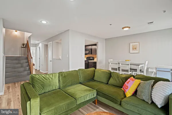 a living room with a couch and a wooden floor
