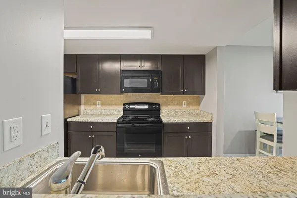 a kitchen with a sink and a stove top oven