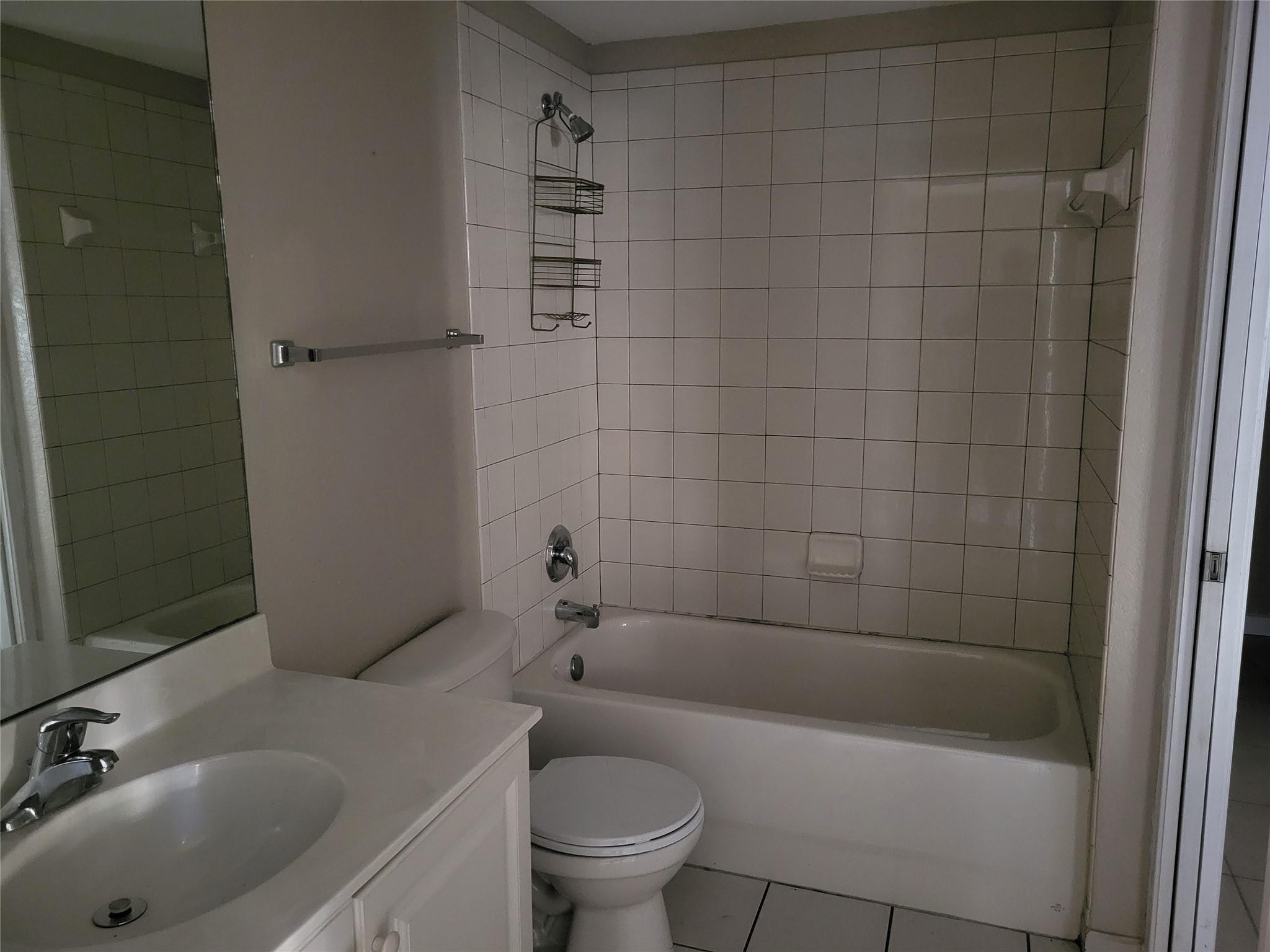 1957 Freeport Drive, Unit 1957 Riviera Beach, FL 33404 - Photo 4 of 14 a bathroom with a sink a toilet and bathtub